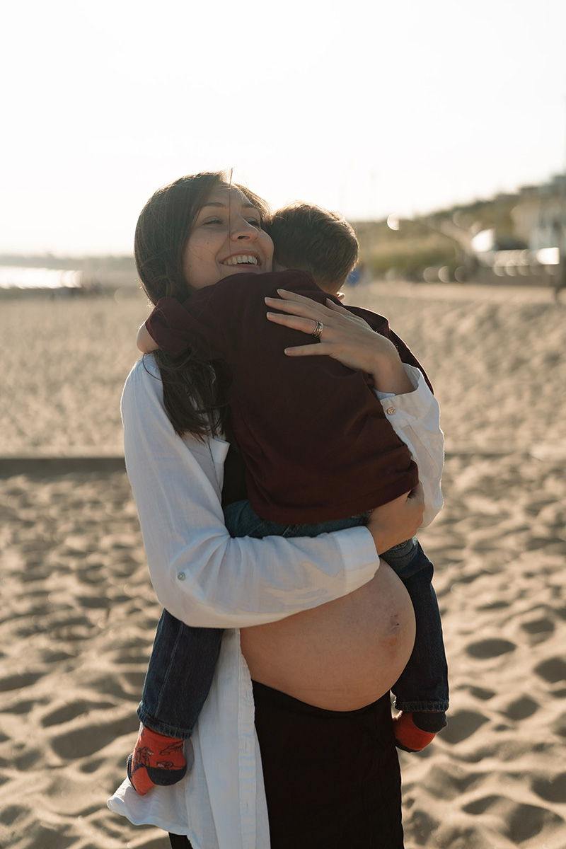 Abby during pregnancy holding her child