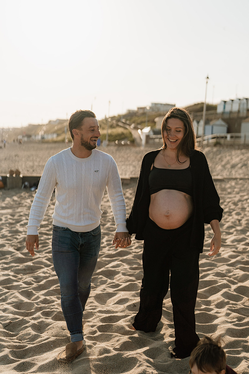 Abby during pregnancy walking on the beach